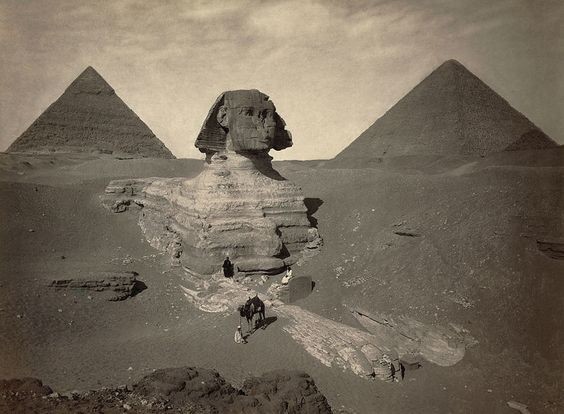 A rare, ancient photograph of the Sphinx (and Khufu's and Khafre's Pyramid) before it was completely excavated.