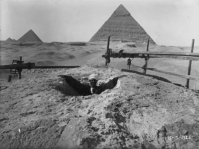 A man standing in a cavity at the head of the Great Sphinx.