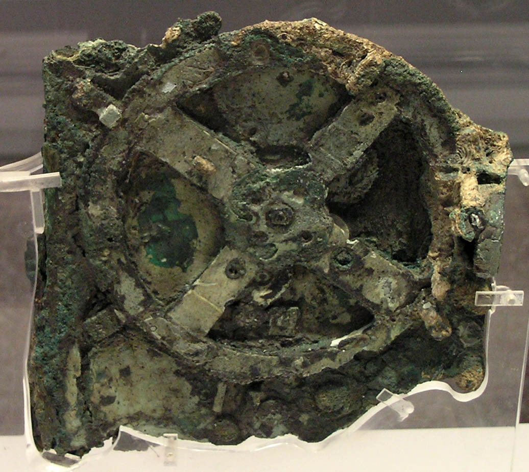 The Antikythera mechanism (Fragment A – front); visible is the largest gear in the mechanism, approximately 14 centimeters (5.5 in) in diameter. Image Credit: Wikimedia Commons.