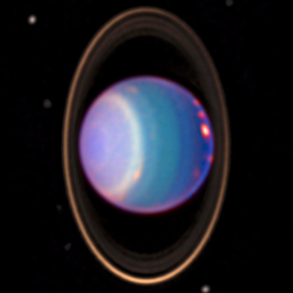 A 1998 false-colour near-infrared image of Uranus showing cloud bands, rings, and moons obtained by the Hubble Space Telescope's NICMOS camera. Image Credit: Wikimedia Commons.