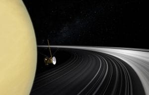 An artist's concept of the Cassini orbiter crossing Saturn's ring plane. New measurements of the rings' mass give scientists the best answer yet to the question of their age. Image Credit: NASA/JPL-Caltech.