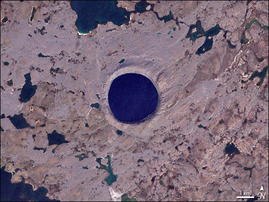 NASA’s Landsat 7 satellite captured this image of Pingualuit Crater on August 17, 2002. In it, water appears blue, and land appears in varying shades of beige. With a diameter of 2.14 miles (3.44 kilometers), Pingualuit Crater holds a lake about 876 feet (267 meters) deep. Credits: NASA