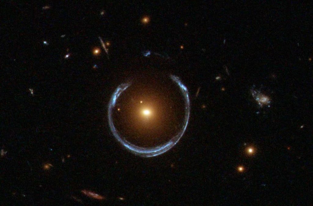 Gravitational lens mirage around a galaxy. Image Credit: NASA.