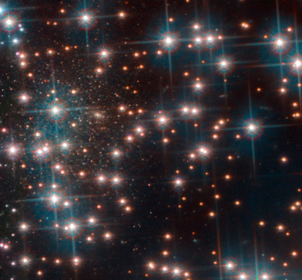 This image, taken with Hubble’s Advanced Camera for Surveys shows a part the globular cluster NGC 6752. Behind the bright stars of the cluster a denser collection of faint stars is visible — a previously unknown dwarf spheroidal galaxy. This galaxy, nicknamed Bedin 1, is about 30 million light-years from Earth. Image Credit: ESA/Hubble, NASA, Bedin et al.