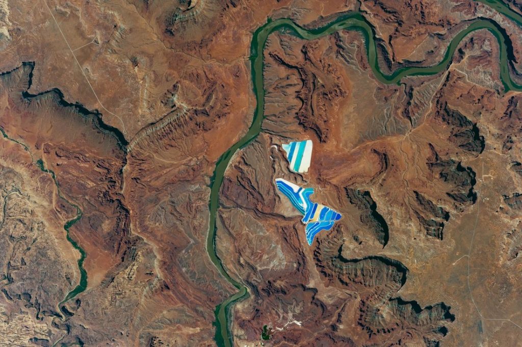 Another photographs taken in space shows solar evaporation ponds outside the city of Moab, Utah. There are 23 colorful ponds spread across 400 acres. Image Credit: NASA.