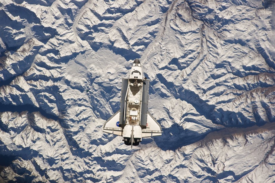 Space Shuttle Atlantis seen orbiting Earth high above the Andes Mountains. Image Credit: NASA.