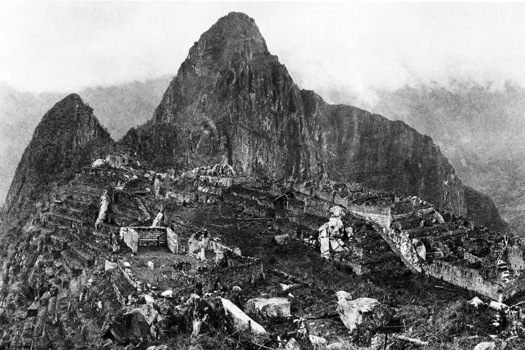 View of the city of Machu Picchu in 1912 showing the original ruins after major clearing and before modern reconstruction work began. Image Credit: Wikimedia Commons.