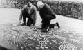 Experts examining the Cochno stone. Image Credit: Royal Commission on the Ancient and Historical Monuments of Scotland.