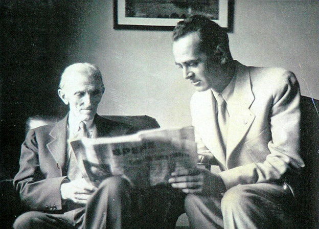 Nikola Tesla reading a newspaper.