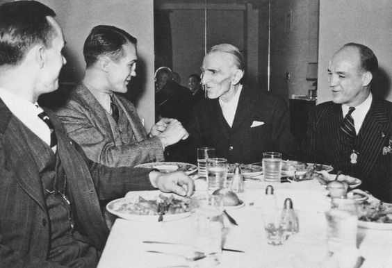 Photograph of Nikola Tesla during a dinner event.