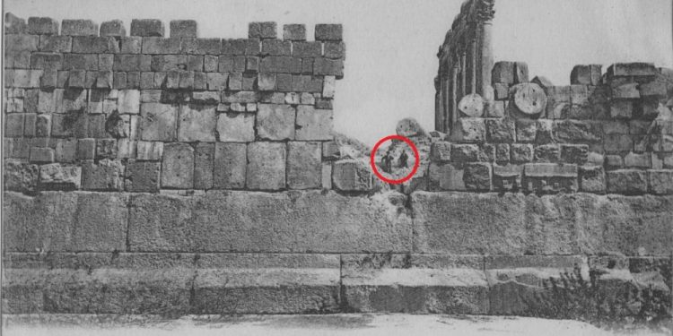 A stunning view of the massive, 1,200-ton block of stone at Baalbek, compared to two people sitting above it.