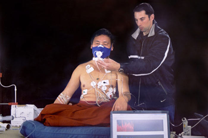 A Buddhist monk has his vital signs measured as he prepares to enter an advanced state of meditation in Normandy, France. During meditation, the monk’s body produces enough heat to dry cold, wet sheets put over his shoulders in a frigid room Image Credit: Herbert Benson.