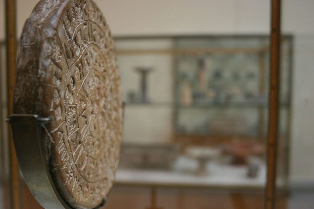 A Side view of the Phaistos Disk. Image Credit: Wikimedia Commons.