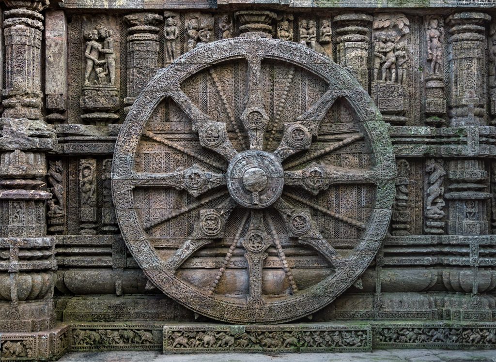 A stone wheel engraved in the walls of the temple. The temple is designed as a chariot consisting of 24 such wheels. Each wheel has a diameter of 9 feet, 9 inches, with 8 spokes. Image Credit: Wikimedia Commons.