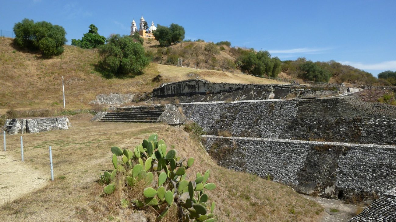 View of the ruins of the Great Pyramid of Cholula which remains as an artificial hill with trees and where was built the Church of Our Lady of Remedies. Shutterstock. 