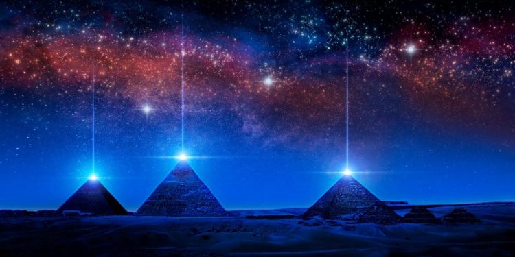 An artists illustration of pyramids with a glowing pyramidion. Shutterstock.