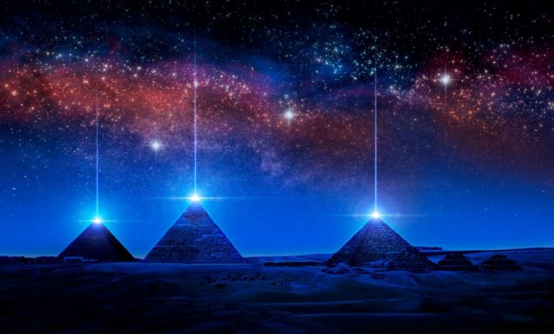 An artists illustration of pyramids with a glowing pyramidion. Shutterstock.
