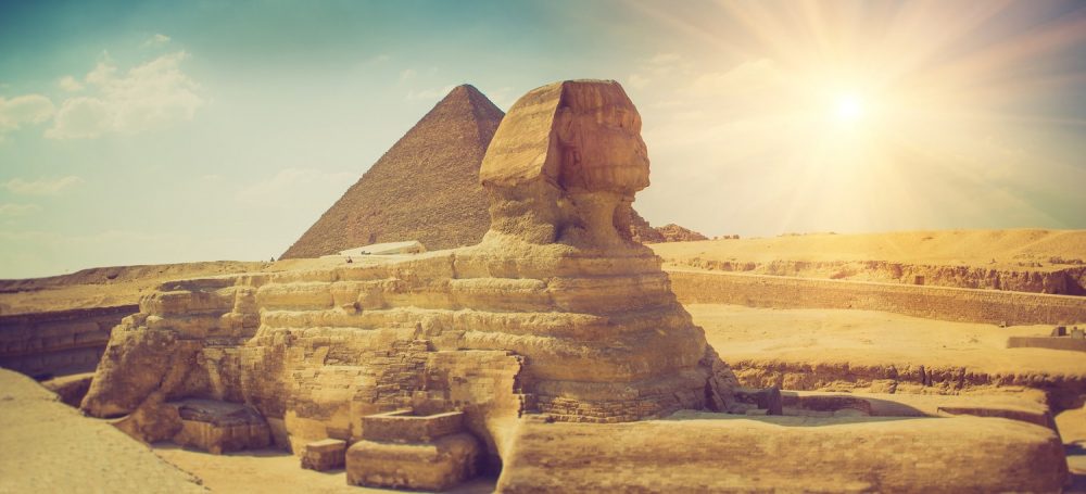 An image of the Sphinx with the pyramid in the background.