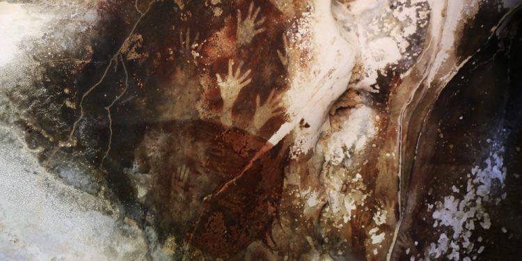 Sulawesi Cave Art with hand imprints, Indonesia. Shutterstock.