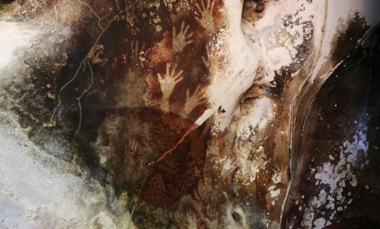 Sulawesi Cave Art with hand imprints, Indonesia. Shutterstock.