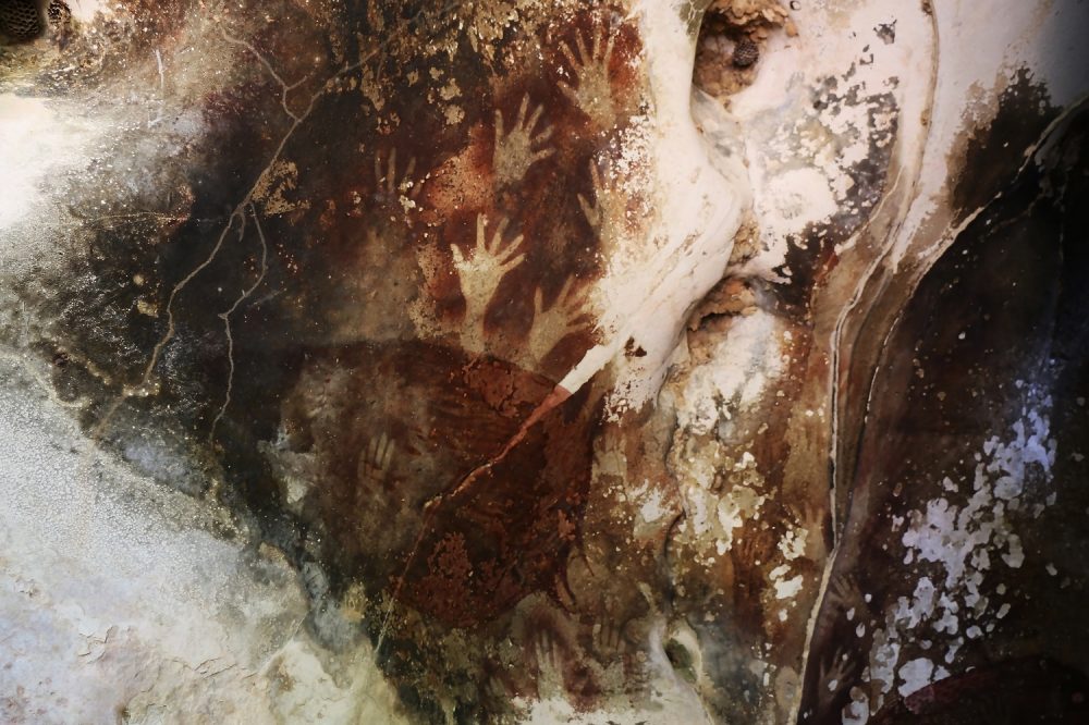 Sulawesi Cave Art with hand imprints, Indonesia. Shutterstock.