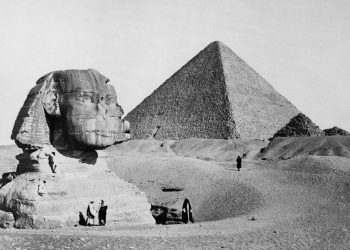 The Great Sphinx with the Pyramid of Pharaoh Cheops in the background. 1877 photo by French photographer Henri Bechard. Shutterstock.