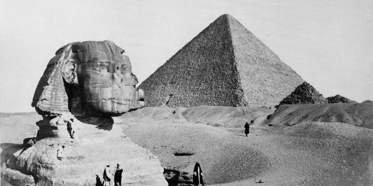 The Great Sphinx with the Pyramid of Pharaoh Cheops in the background. 1877 photo by French photographer Henri Bechard. Shutterstock.