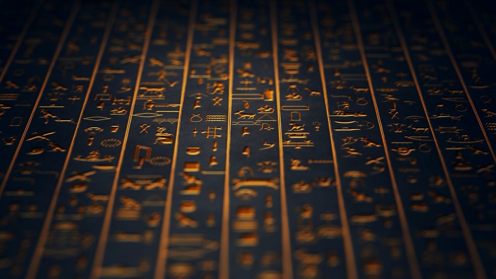 Golden Ancient Egyptian Hieroglyphs. Shutterstock.