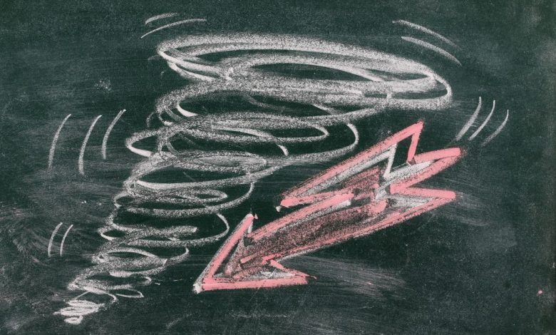 Chalkboard Drawing of a Tornado and an arrow. Shutterstock.