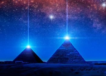 Pyramids and light above the night sky. Shutterstock.