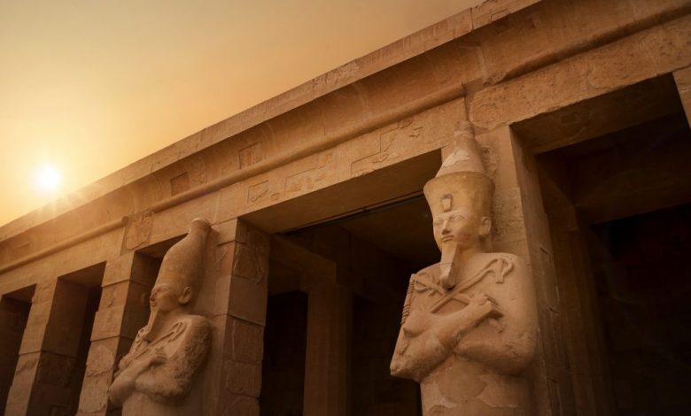 Ancient Egyptian statues and temple. Shutterstock.
