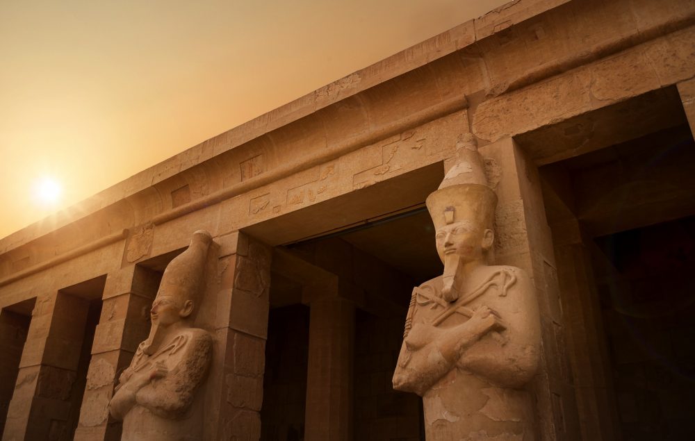 Ancient Egyptian statues and temple. Shutterstock.