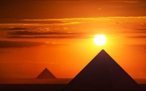 An image of pyramids and the sunset. Shutterstock.