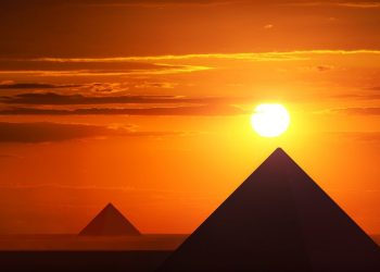 An image of pyramids and the sunset. Shutterstock.