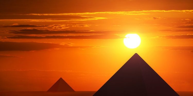 An image of pyramids and the sunset. Shutterstock.