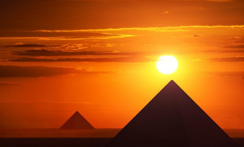 An image of pyramids and the sunset. Shutterstock.