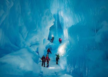Explorers from the 24th Ukrainian Antarctic Expedition standing inside the subterranean world. Image Credit: Press Service of the Ministry of Education and Science of Ukraine.