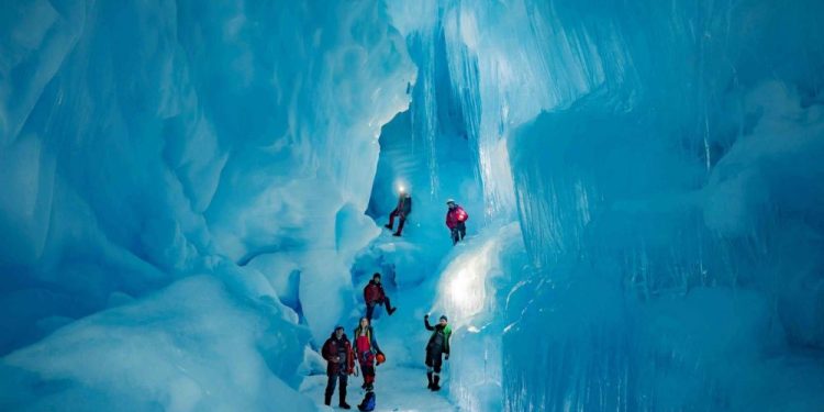 Explorers from the 24th Ukrainian Antarctic Expedition standing inside the subterranean world. Image Credit: Press Service of the Ministry of Education and Science of Ukraine.