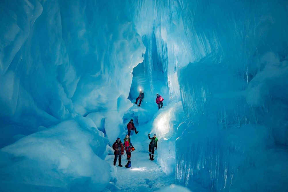 Explorers from the 24th Ukrainian Antarctic Expedition standing inside the subterranean world. Image Credit: Press Service of the Ministry of Education and Science of Ukraine.