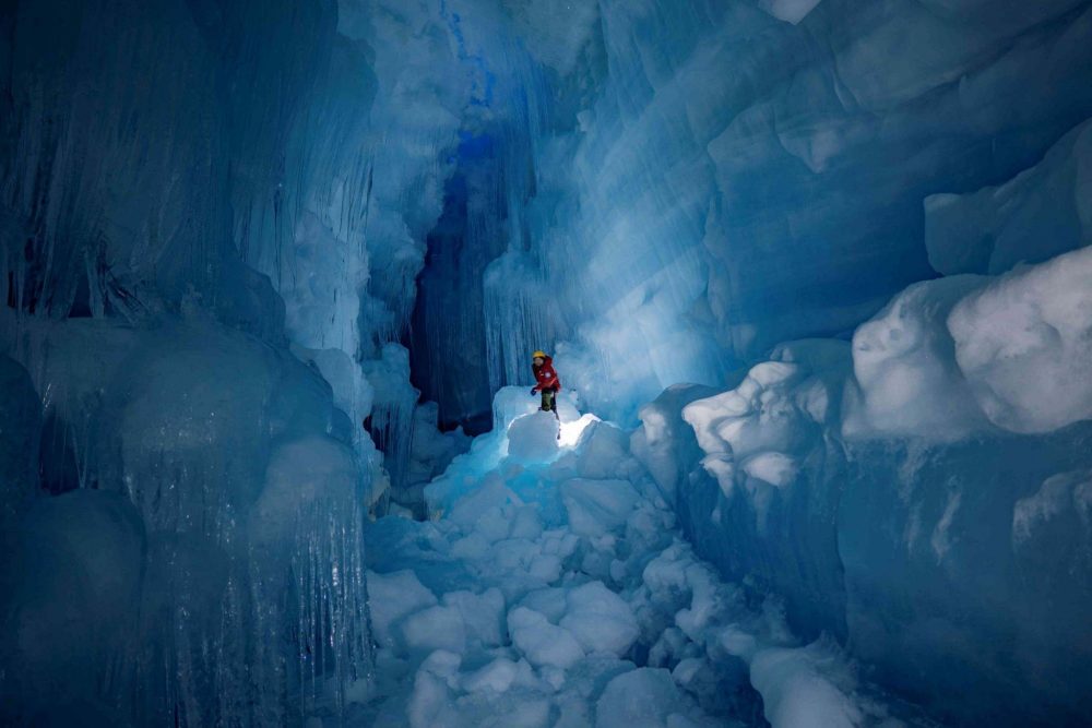 A researcher standing inside the mysterious cave. Image Credit: Press Service of the Ministry of Education and Science of Ukraine.