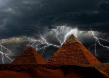 Pyramids and Storm in the background. Shutterstock.