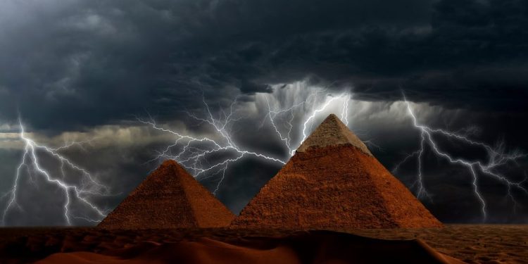 Pyramids and Storm in the background. Shutterstock.