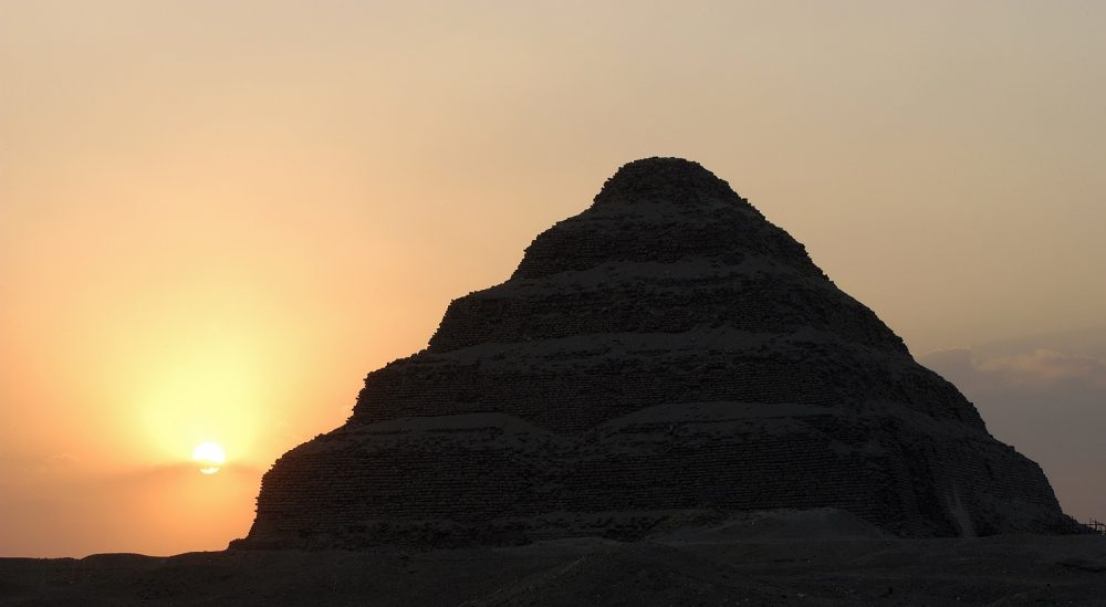 The Step Pyramid of Saqqara and the Sun in the background. Shutterstock.