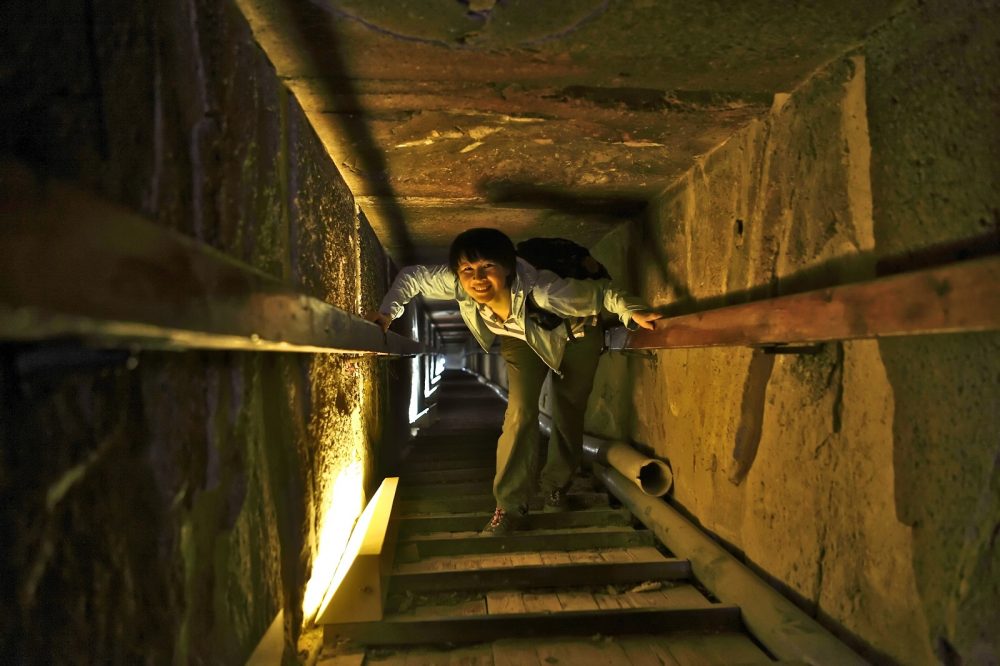 Tourist inside the tunnel of the Red Pyramid at Dahshur. Shutterstock.
