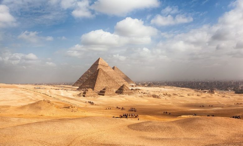 A view of the Giza Pyramid Complex with the city of Giza in the background. Shutterstock.