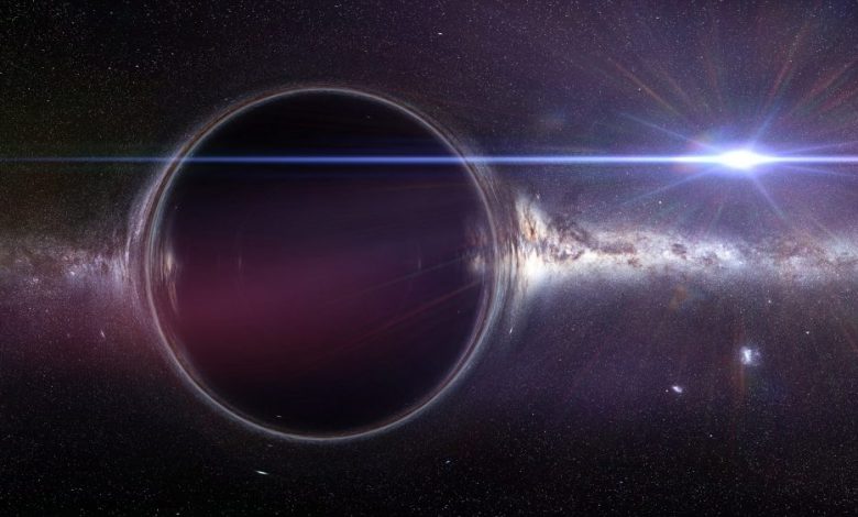 An artists rendering of a black hole with a gravitational lens effect and the Milky Way galaxy. Shutterstock.