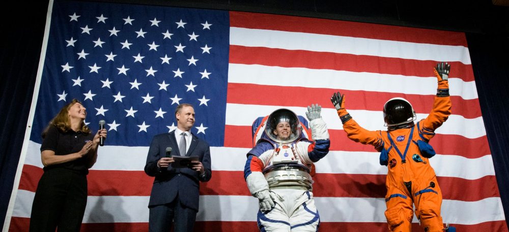 Two of the new spacesuits presented by NASA for the 2024 moon landing mission are seen in this image. Image Credit: NASA / NASA HQ Photo / Flickr.