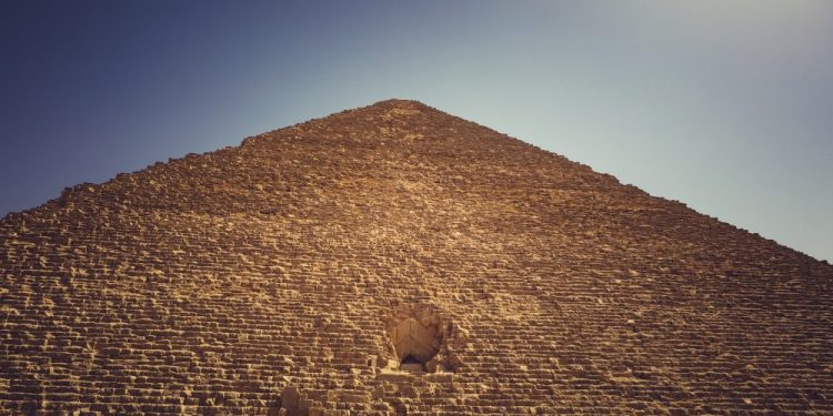 A view of the Great Pyramid of Giza, its entrance and people accessing it. Shutterstock.