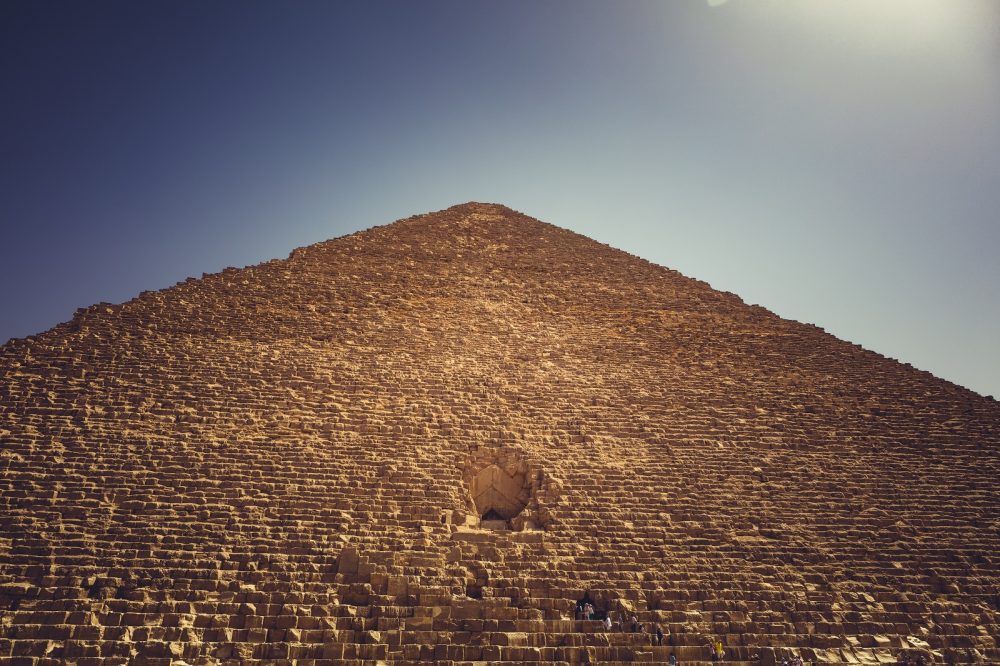 A view of the Great Pyramid of Giza, its entrance and people accessing it. Shutterstock.