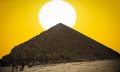 An image of the Great Pyramid of Giza with the Sun in the background. Shutterstock.